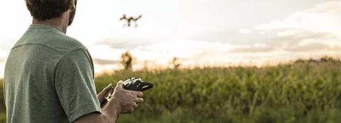 man using drone in the field