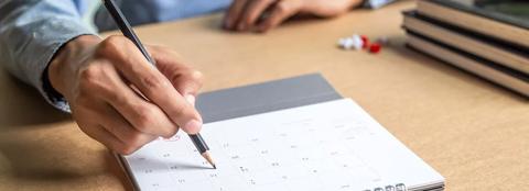 hand scheduling a meeting on calendar