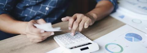 man making calculations on a calculator