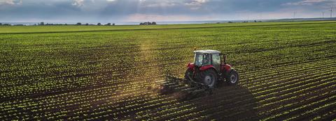Tractor tilling a field