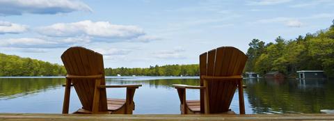 two chairs overlooking a lake