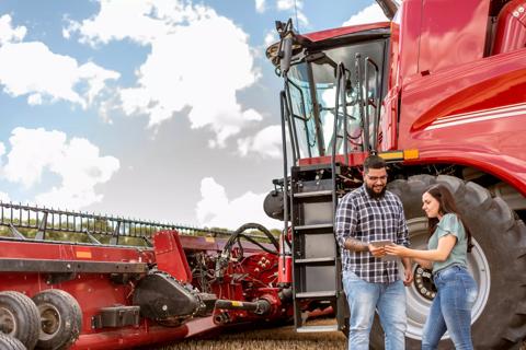 Agronomist and farmer using digital tablet in wheat plantation