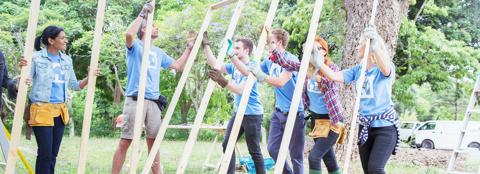 young adults helping to build structure