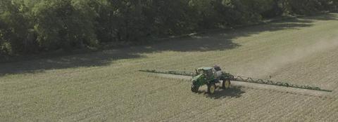 Ag equipment in farmland in early planting and spray